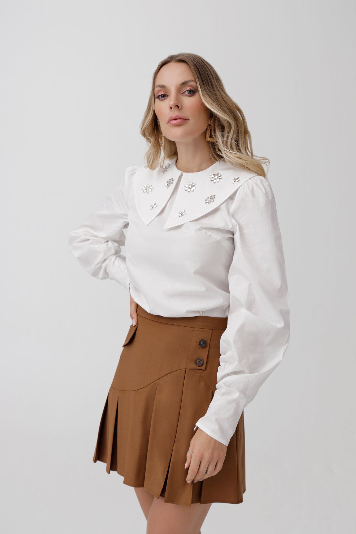 
                  
                    Pleated button detailed skirt
                  
                